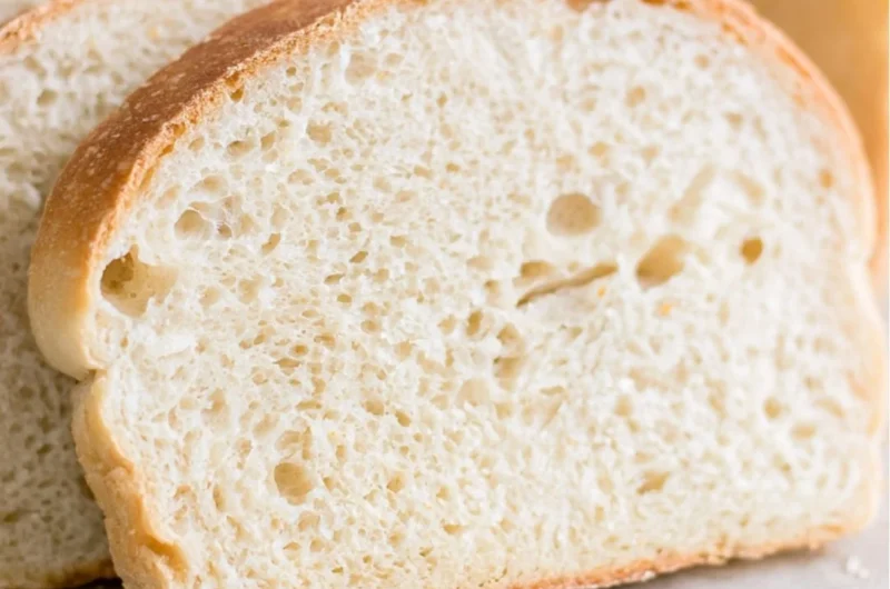 Loaf of super soft easy sourdough sandwich bread on a wooden cutting board