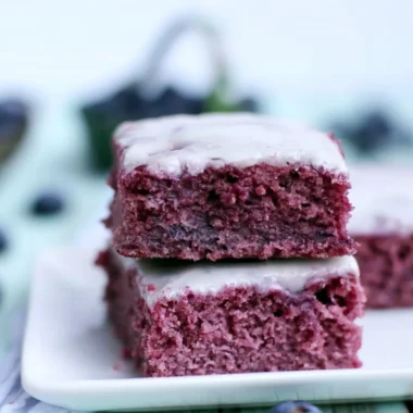 Delicious glazed blueberry brownies topped with fresh blueberries