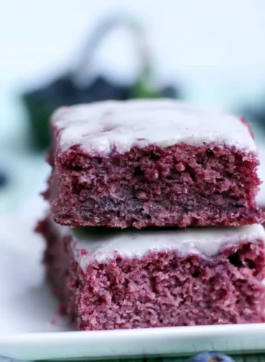 Delicious glazed blueberry brownies topped with fresh blueberries