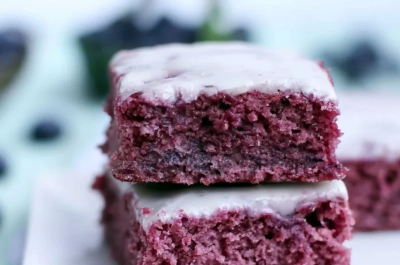 Delicious glazed blueberry brownies topped with fresh blueberries