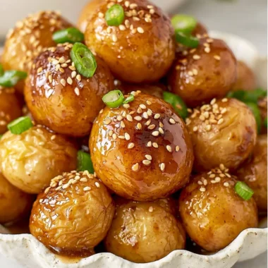 Delicious bowl of Korean braised potatoes served with sesame seeds