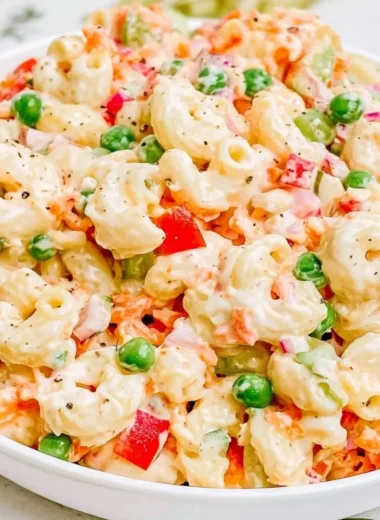 Delicious homemade macaroni salad with fresh vegetables and creamy dressing.