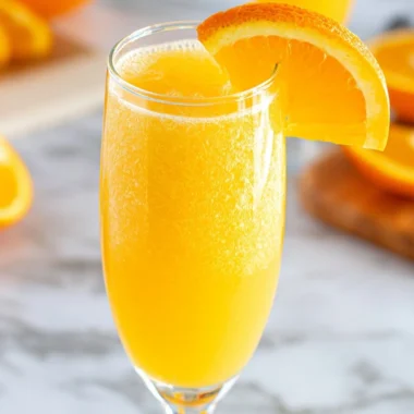 A refreshing Non-Alcoholic Mimosa in a glass with orange juice and sparkling water.
