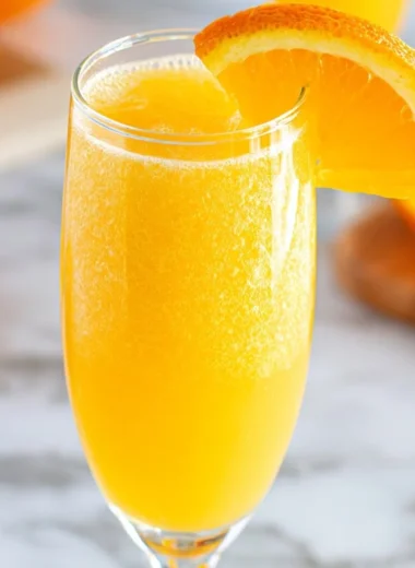 A refreshing Non-Alcoholic Mimosa in a glass with orange juice and sparkling water.