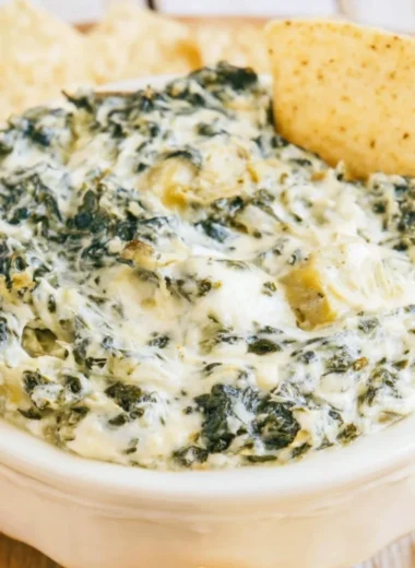 Delicious slow cooker spinach artichoke dip served with tortilla chips