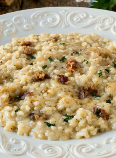 Delicious three cheese risotto served in a bowl, showcasing creamy texture and rich flavor.