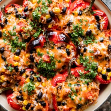 Colorful vegetarian stuffed peppers filled with grains and vegetables