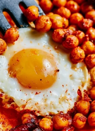 Plate of chickpea fried eggs garnished with herbs and spices