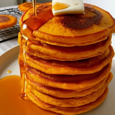 Fluffy pumpkin pancakes with cottage cheese topped with syrup and spices