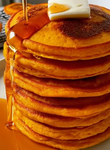 Fluffy pumpkin pancakes with cottage cheese topped with syrup and spices