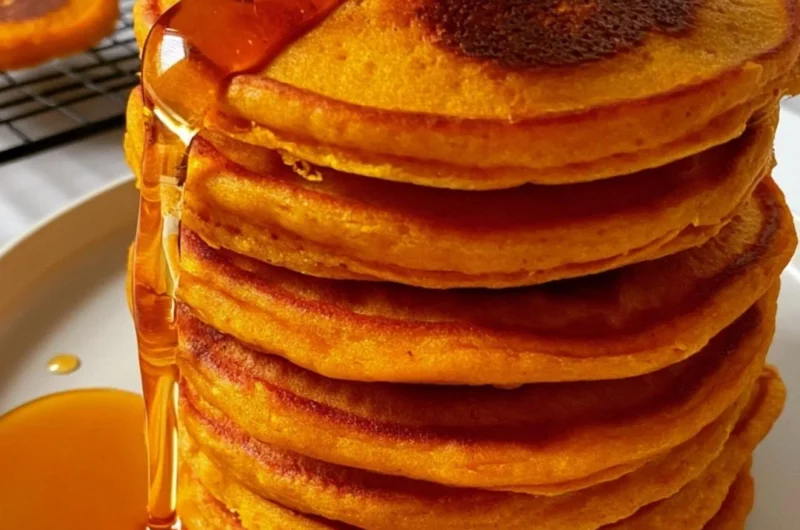 Fluffy pumpkin pancakes with cottage cheese topped with syrup and spices