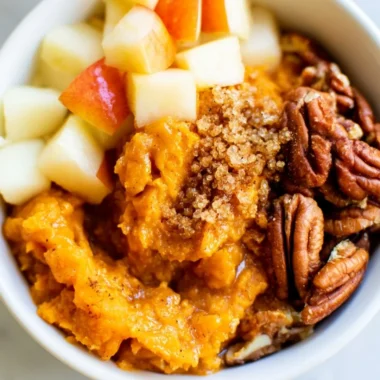 Sweet potato breakfast bowl with pecans and apples, a healthy warm breakfast dish